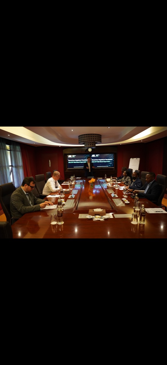 Participants seated around a conference table while a presenter leads a discussion.